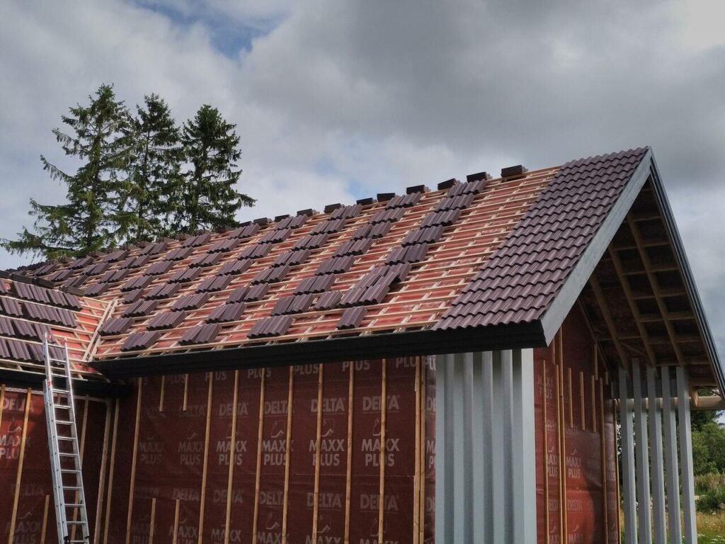 Katusekatte paigaldus pooleldi valmis fassaadiga majale – paekivi ja puit kombineeritult